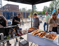 Mensen staan bij ontbijtbuffet op bouwterrein